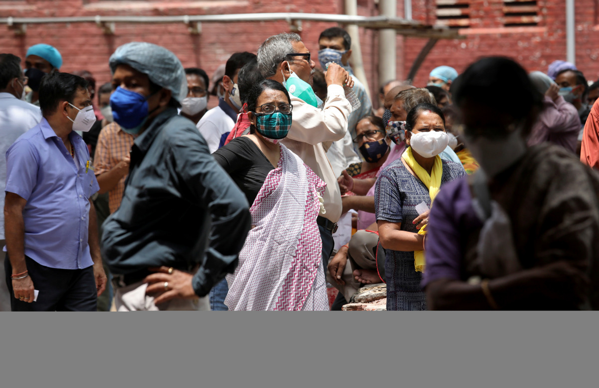 People wearing protective face masks wait to receive their second dose of COVISHIELD, a coronavirus disease (COVID-19) vaccine manufactured by Serum Institute of India, outside a vaccination centre in Kolkata, India, May 12, 2021. REUTERS/Rupak De Chowdhu