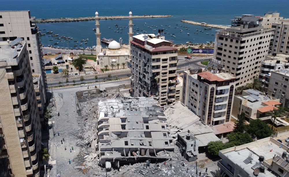 A picture taken with a drone shows the remains of a tower building which was destroyed in Israeli air strikes, amid a flare-up of Israeli-Palestinian violence, in Gaza City May 12, 2021. REUTERS/Mohammed Salem