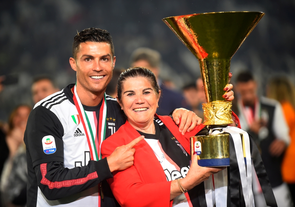 May 19, 2019 Juventus' Cristiano Ronaldo poses with his mother Maria Dolores dos Santos Aveiro as he celebrates winning Serie A with the trophy REUTERS/Massimo Pinca/File Photo