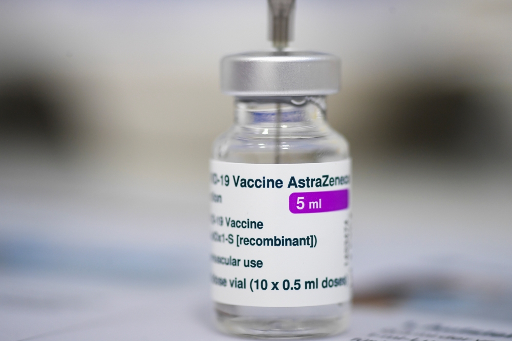 A medical worker fills a syringe with a vaccine at a COVID-19 vaccination center offering the AstraZeneca vaccine, as the number of the coronavirus disease infections decreases in Munich, Germany, May 13, 2021. REUTERS/Andreas Gebert