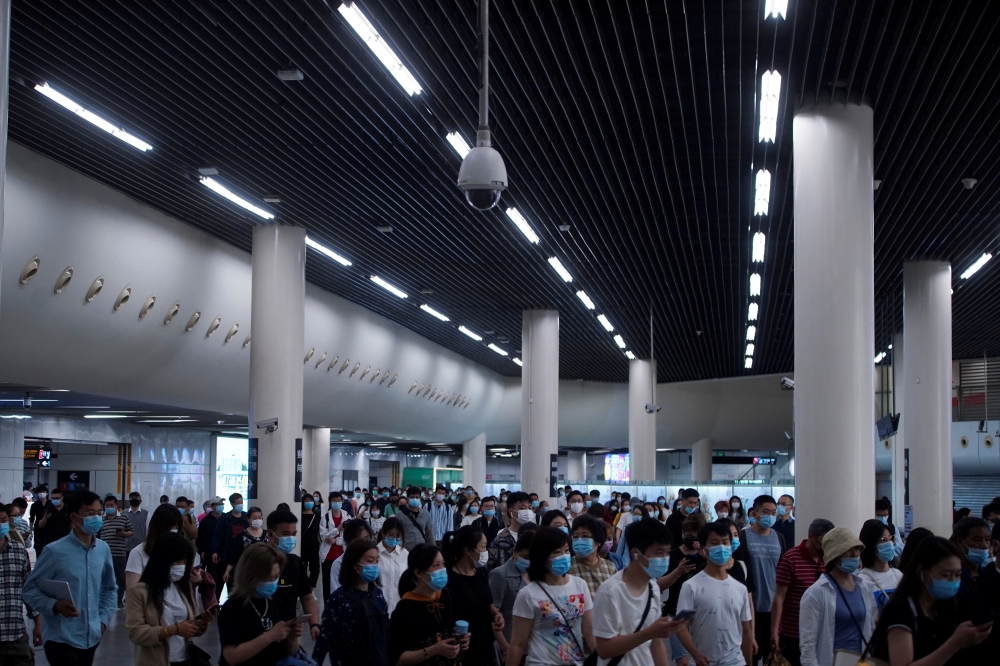 People walk at a subway station, following the outbreak of the coronavirus disease (COVID-19), in Shanghai, China May 11, 2021. REUTERS/Aly Song