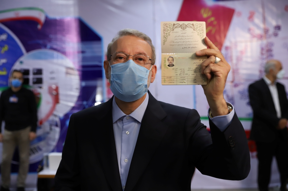 Ali Larijani, former chairman of the parliament of Iran, shows his identification document as he registers as a candidate for the presidential election at the Interior Ministry, in Tehran, Iran May 15, 2021. Majid Asgaripour/ WANA (West Asia News Agency) 