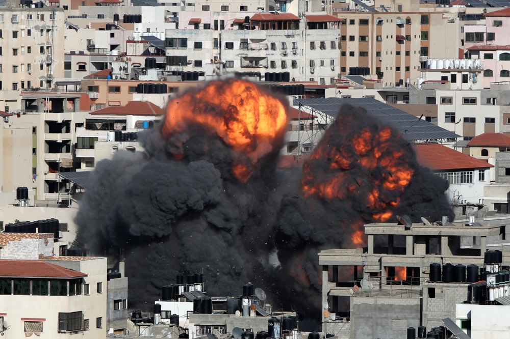 Smoke and flames rise during an Israeli air strike, amid a flare-up of Israeli-Palestinian violence, in Gaza City May 14, 2021. REUTERS/Mohammed Salem