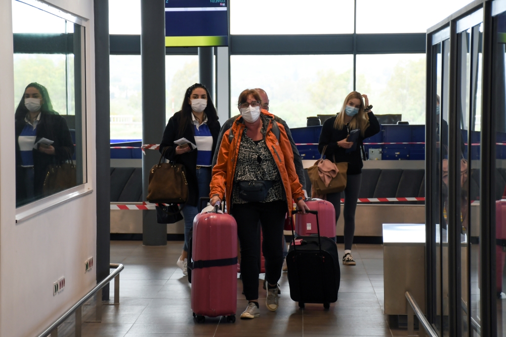 assengers of TUI Airways flight from Dusseldorf arrive at Ioannis Kapodistrias International Airport, as the country's tourism season officially opens, on the island of Corfu, Greece, May 15, 2021. REUTERS/Adonis Skordilis