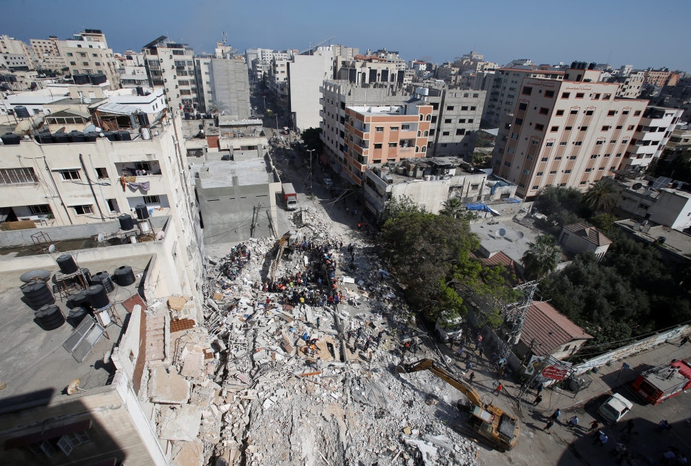 A general view as rescue workers search for victims amid rubble at the site of Israeli air strikes, in Gaza City May 16, 2021. REUTERS/Mohammed Salem
 