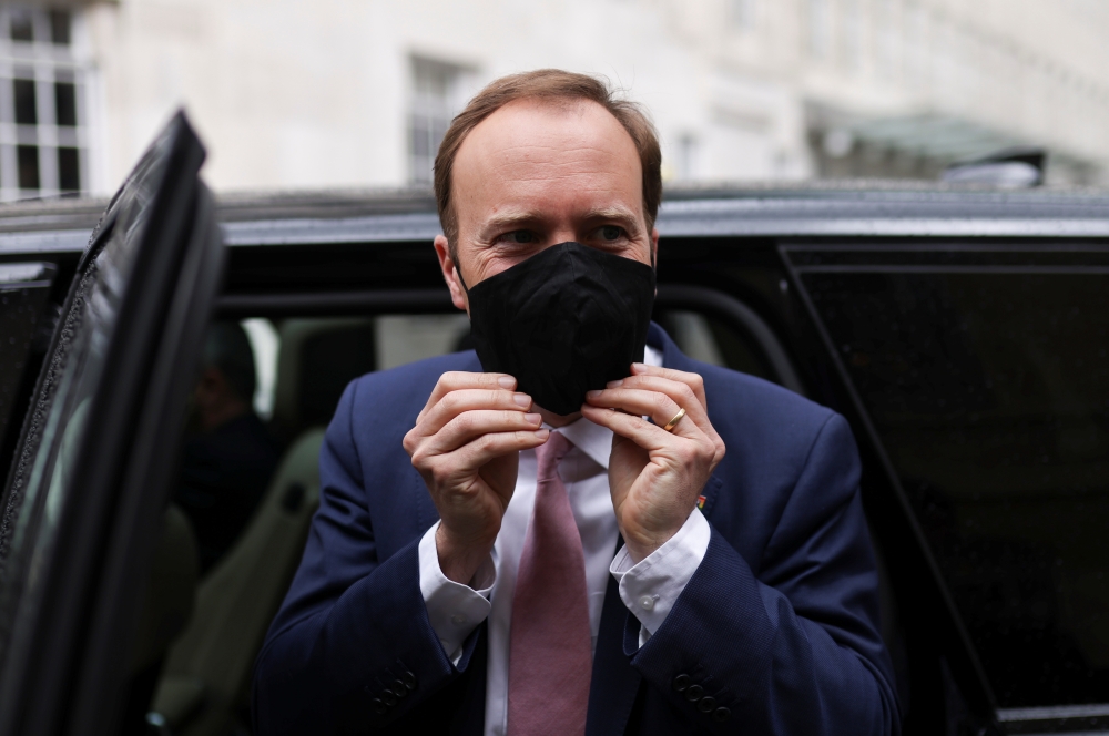 Britain's Health Secretary Matt Hancock adjusts his protective mask as he leaves BBC Broadcasting House in London, Britain, May 16,2021. Reuters/Tom Nicholson
