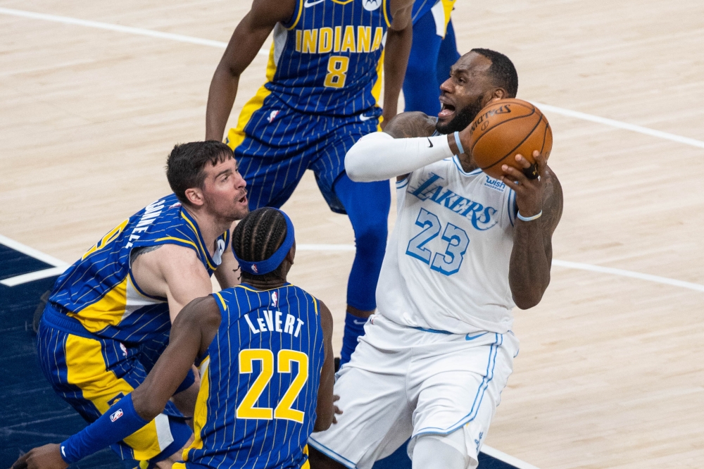 Los Angeles Lakers forward LeBron James (23) pulls up his dribble while a few Indiana Pacers defend in the fourth quarter at Bankers Life Fieldhouse. Pic: Trevor Ruszkowski-USA TODAY Sports