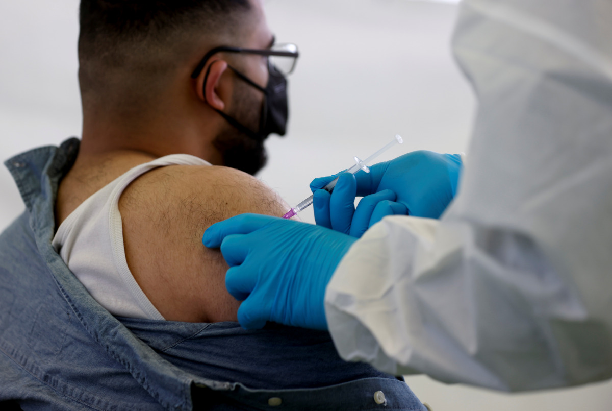 A person receives a vaccine against the coronavirus disease (COVID-19) at a sports hall in Berlin, Germany, May 14, 2021. REUTERS/Axel Schmidt
