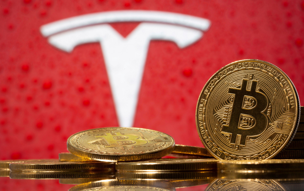 FILE PHOTO: Representations of virtual currency Bitcoin are seen in front of Tesla logo in this illustration taken, February 9, 2021. REUTERS/Dado Ruvic/File Photo/File Photo
