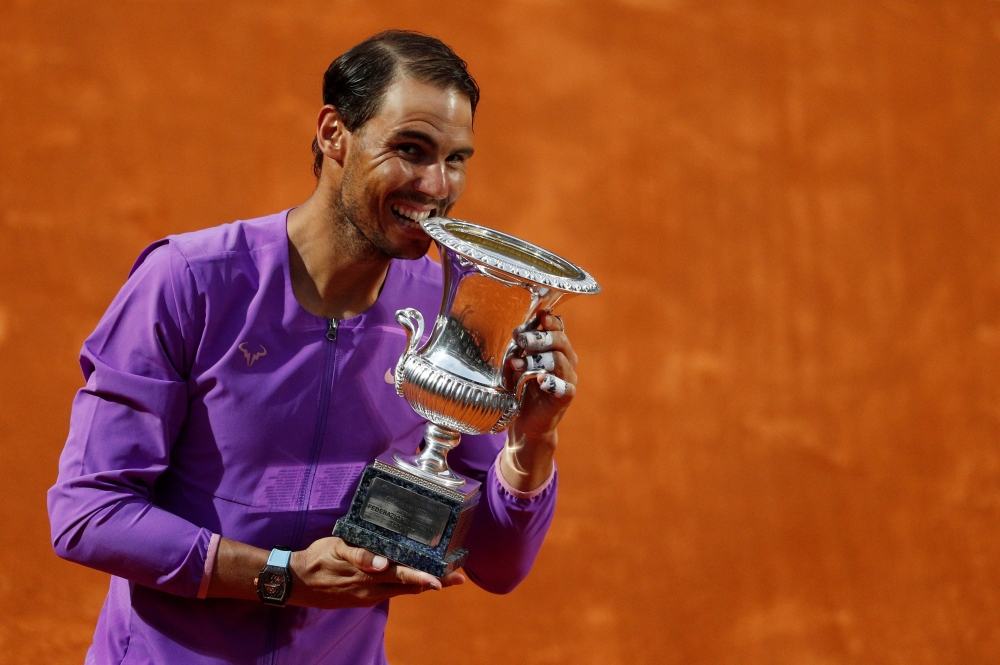 Spain's Rafael Nadal celebrates with the trophy after winning his final match against Serbia's Novak Djokovic... Reuters/Guglielmo Mangiapane 
