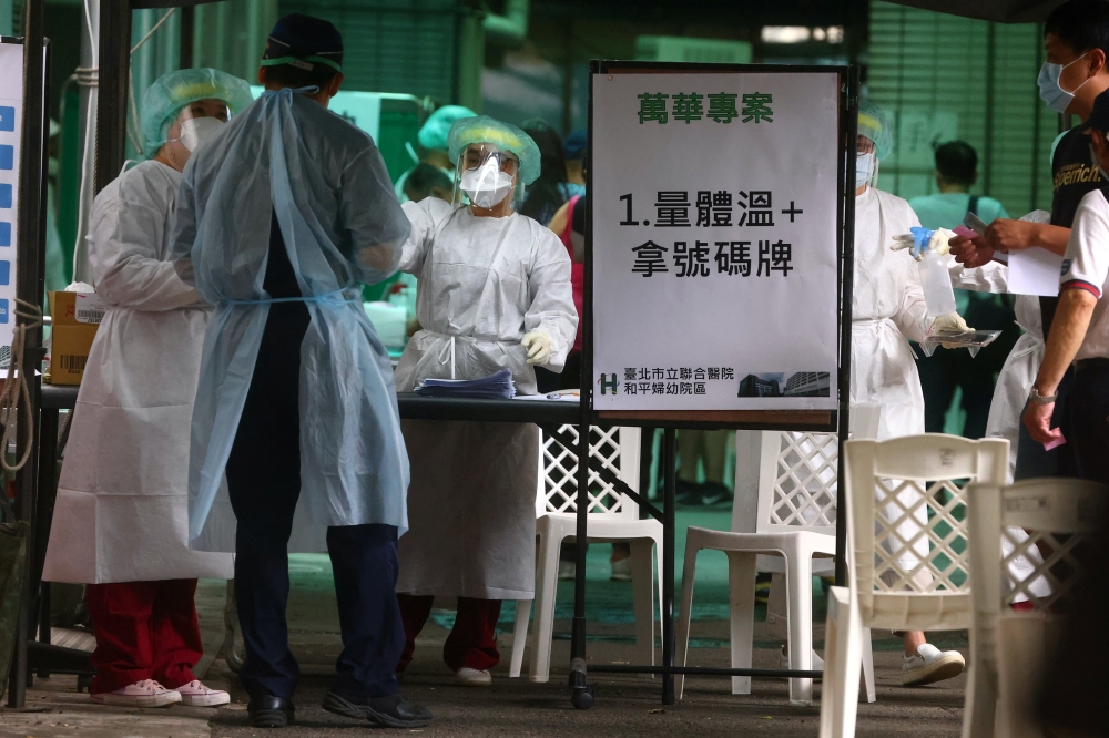 A healthcare frontline worker prepares people to get their rapid test following a surge of coronavirus disease (COVID-19) infections in Taipei, Taiwan May 17, 2021. REUTERS/Ann Wang