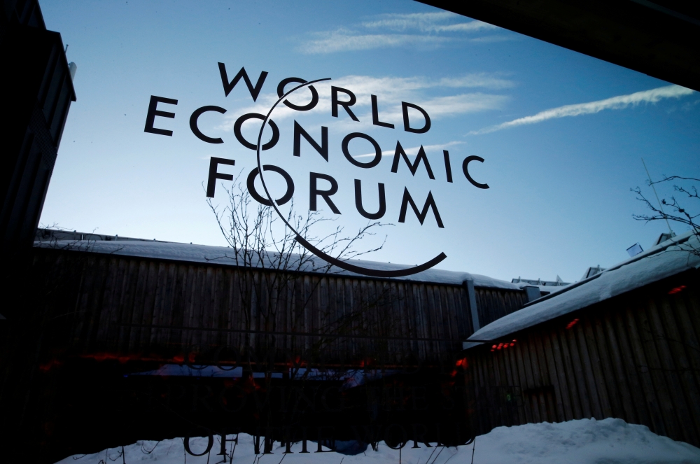A logo of the 50th World Economic Forum (WEF) annual meeting is pictured on a window in Davos, Switzerland, January 21, 2020. REUTERS/Denis Balibouse/File Photo