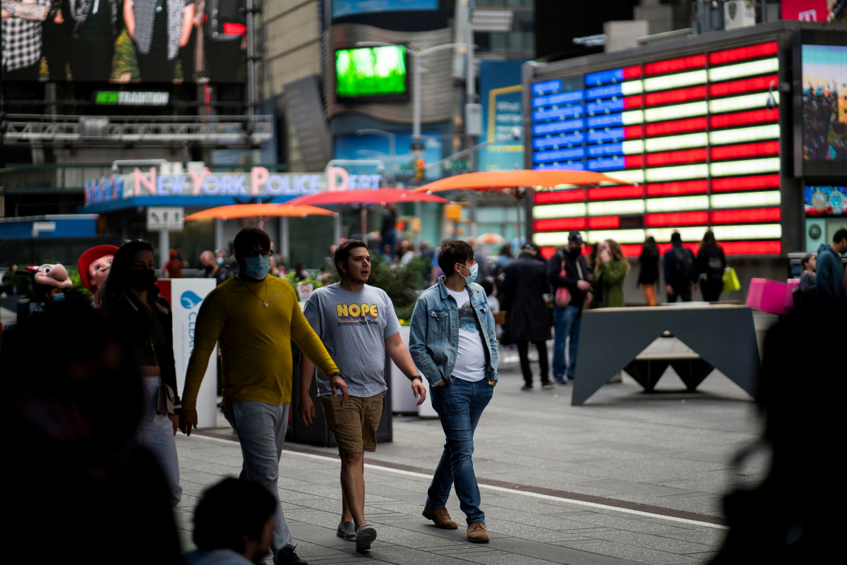 People make their way through Times Square, amid the coronavirus disease (COVID-19) pandemic, in Manhattan, New York City, U.S., May 07, 2021. REUTERS/Eduardo Munoz/File Photo

