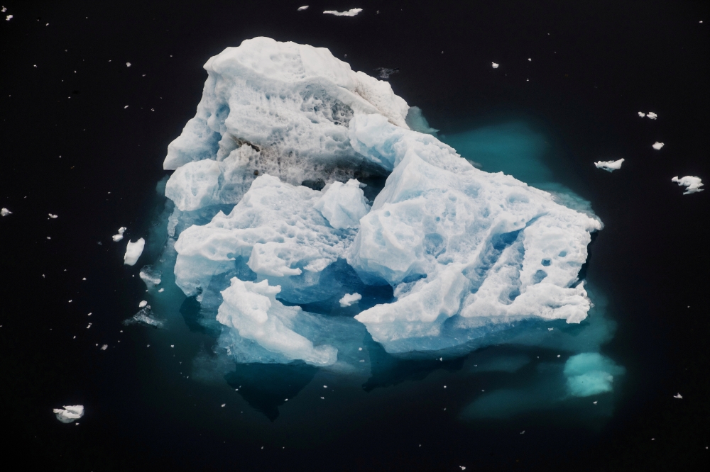 An iceberg floats in a fjord near the town of Tasiilaq, Greenland, June 24, 2018. REUTERS/Lucas Jackson/File Photo