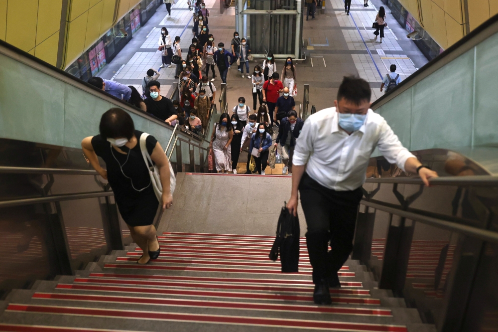 People wear protective face masks while at a metro station, amid a surge in coronavirus disease (COVID-19) infections in Taipei, Taiwan May 18, 2021. REUTERS/Ann Wang