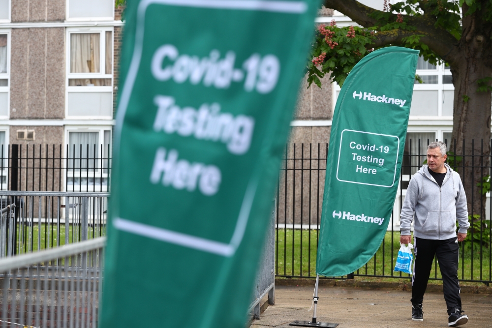 A person walks past a testing centre amid the outbreak of the coronavirus disease (COVID-19), in the Shoreditch area of London, Britain, 18 May 2021. REUTERS/Hannah McKay