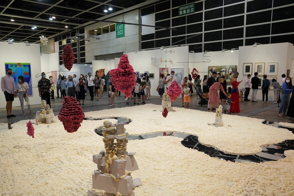 Visitors look at artworks displayed at the Art Basel in Hong Kong, China May 19, 2021. Reuters/Lam Yik