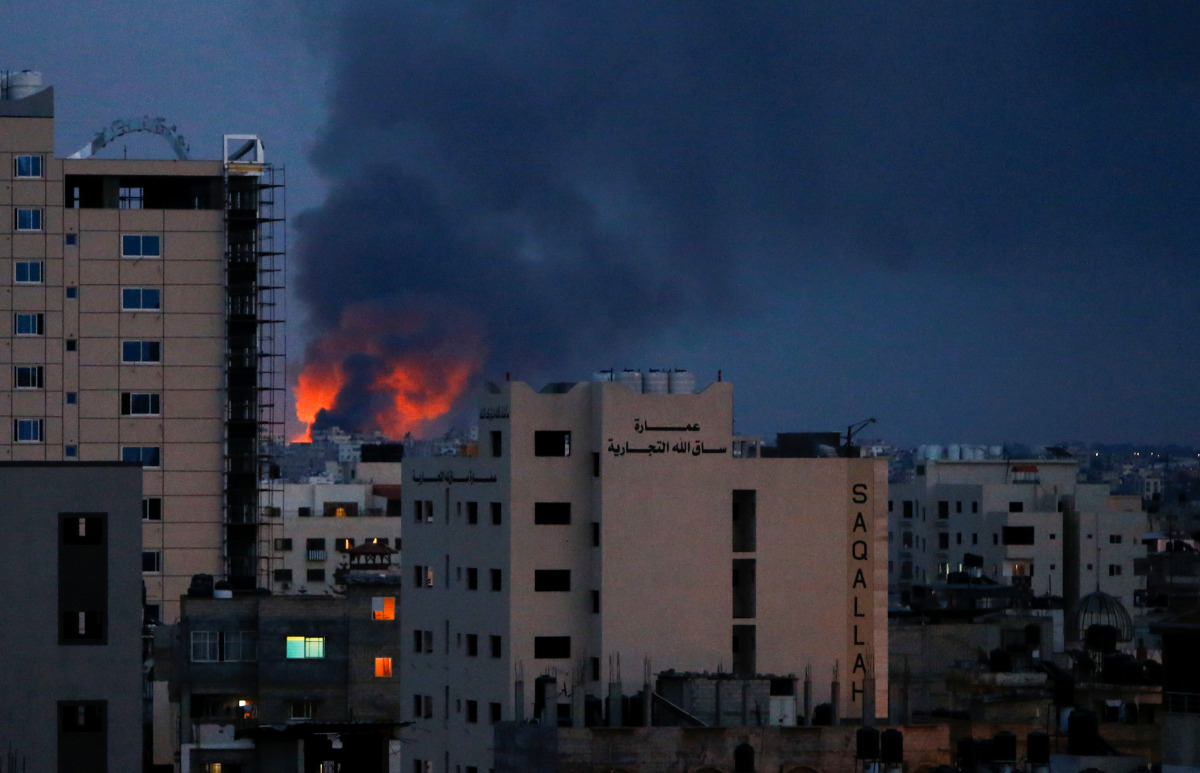 Smoke and flames are seen above buildings, amid a flare-up of Israeli-Palestinian fighting, in Gaza, May 20, 2021. REUTERS/Mohammed Salem

