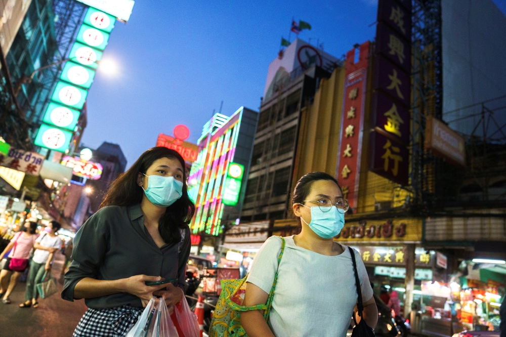 FILE PHOTO: People wearing face masks shop for street food in Chinatown amid the spread of the coronavirus disease (COVID-19) in Bangkok, Thailand, January 6, 2021. REUTERS/Athit Perawongmetha