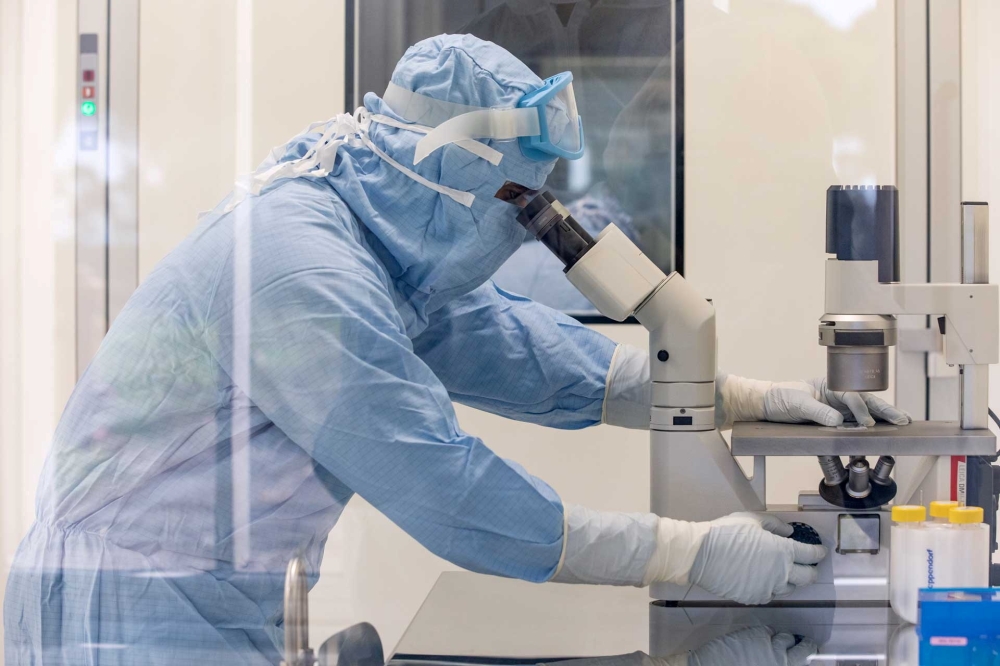 File photo: A researcher works inside a laboratory during the development of the Italian ReiThera COVID-19 vaccine, in this undated handout photo in Rome, Italy. ReiThera/Handout via Reuters/File Photo