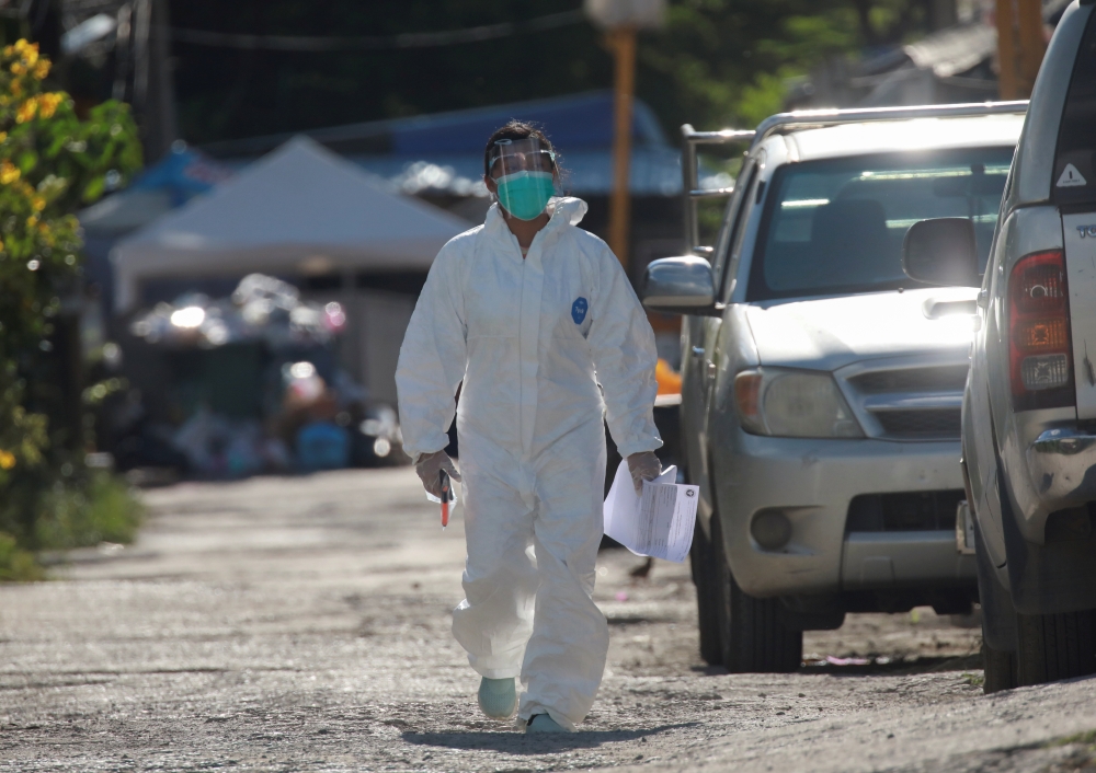 A healthcare worker walks near a workers' dormitory where more than a thousand COVID-19 cases were detected, in Bangkok, Thailand May 22, 2021. REUTERS/Soe Zeya Tun