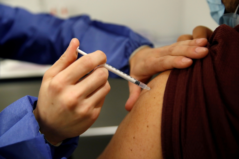 File photo: A medical worker administers a dose of the 