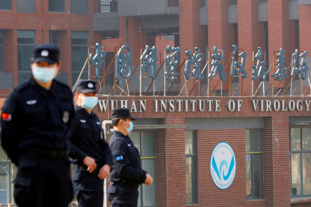 FILE PHOTO: Security personnel keep watch outside the Wuhan Institute of Virology during the visit by the World Health Organization (WHO) team tasked with investigating the origins of the coronavirus disease (COVID-19), in Wuhan, Hubei province, China Feb