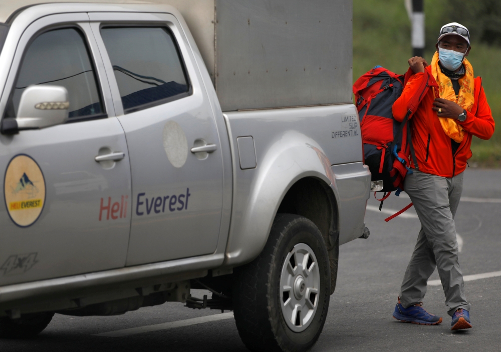 Kami Rita Sherpa, 51, a Nepali mountaineer, walks from a vehicle upon his arrival after climbing Mount Everest for the 25th time, creating a record for the most summits of the world's highest mountain, in Kathmandu, Nepal May 25, 2021. Reuters/Navesh Chit
