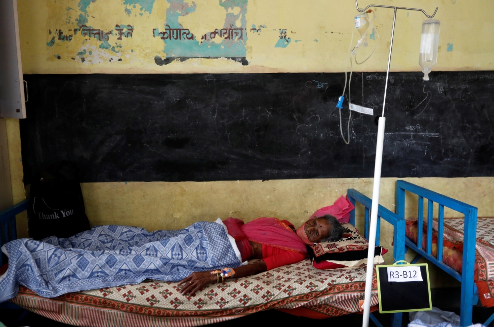 A patient suffering from coronavirus disease rests inside a classroom turned Covid-19 care facility on the outskirts of Mumbai, India, May 24, 2021. Reuters/Francis Mascarenhas