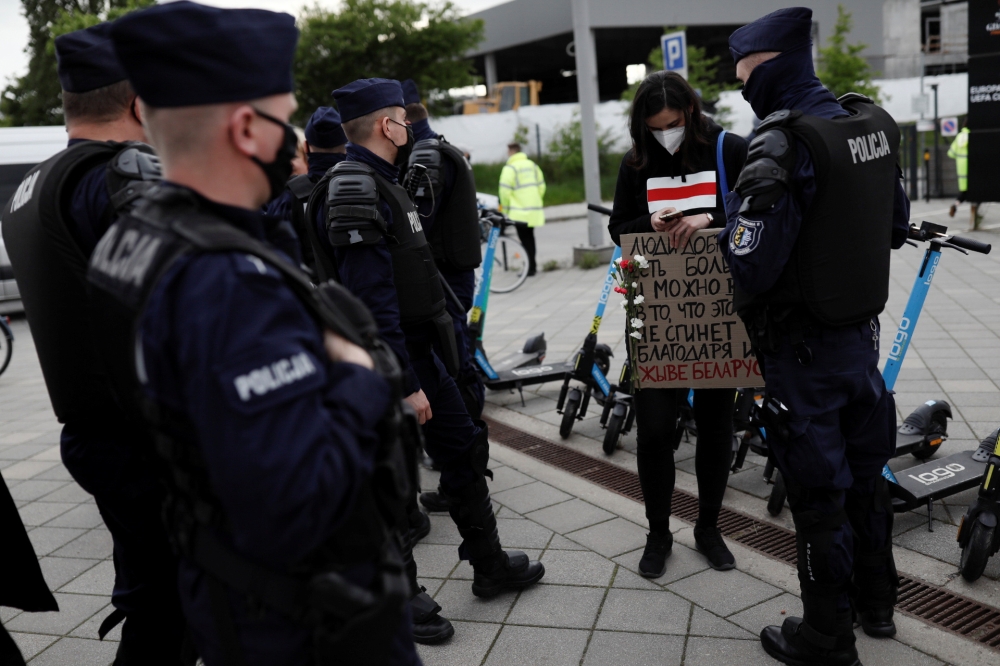 Police check the ID of a woman taking part in a protest against the detention of Belarusian journalist and blogger, Roman Protasevich,  in Gdansk, Poland, May 26, 2021. REUTERS/Kamil Jasinski