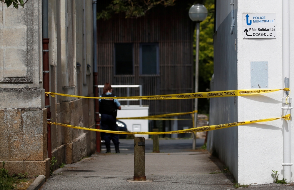 A French gendarme secures the area after an assailant stabbed and badly wounded a policewoman in La Chapelle-sur-Erdre, western France, May 28, 2021. REUTERS/Stephane Mahe