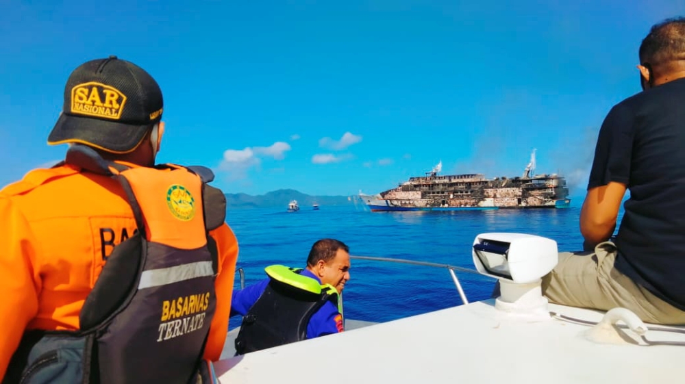 A ferry is seen from a distance during a Barsanas rescue operation after fire broke out on the vessel in North Maluku province, Indonesia, May 29, 2021. Picture taken May 29, 2021. 