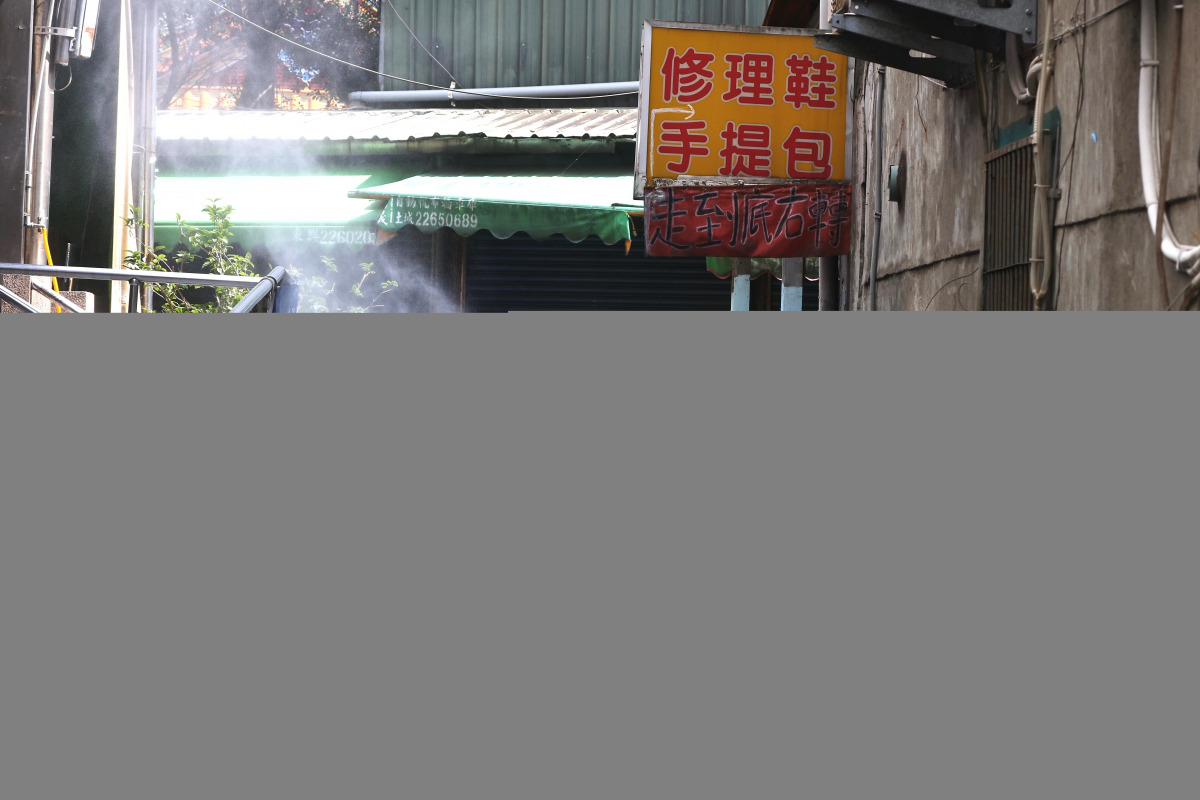 Soldiers in protective suits disinfect a street following the recent surge of coronavirus disease (COVID-19) infections, in Tucheng district of New Taipei City, Taiwan May 27, 2021. REUTERS/Ann Wang
