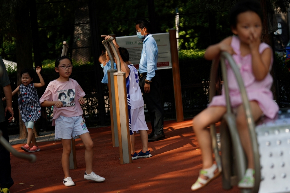 File photo: Children play at an exercise area near Houhai Lake in Beijing, China August 28, 2020.Reuters/Tingshu Wang/File Photo