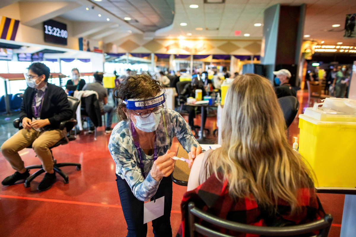 FILE PHOTO: A healthcare worker administers the Pfizer/BioNTech coronavirus disease (COVID-19) vaccine, which was authorized by Canada to be used for children aged 12 to 15, at Woodbine Racetrack pop-up vaccine clinic in Toronto, Ontario, Canada May 5, 20