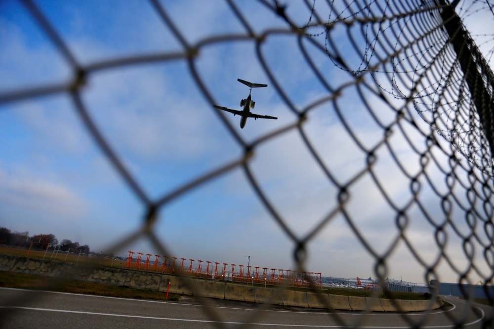 FILE PHOTO: An airplane prepares to land at Cointrin airport in Geneva, Switzerland, December 5, 2017. REUTERS/Pierre Albouy