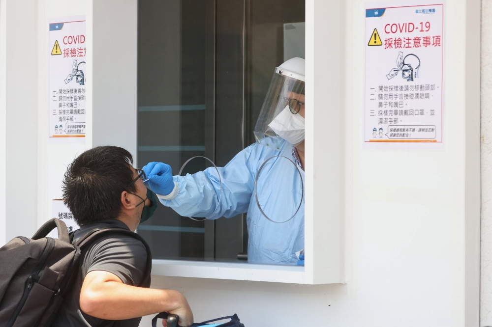 A medical worker conducts a rapid test for coronavirus disease (COVID-19) on a Taiwanese resident following an increasing number of locally transmitted cases at Songshan Airport in Taipei, Taiwan, June 2, 2021. REUTERS/Ann Wang