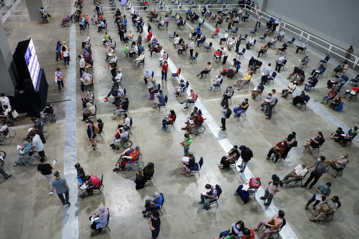People wait to receive coronavirus disease (COVID-19) vaccines at a vaccination centre in Kuala Lumpur, Malaysia May 31, 2021. REUTERS/Lim Huey Teng
