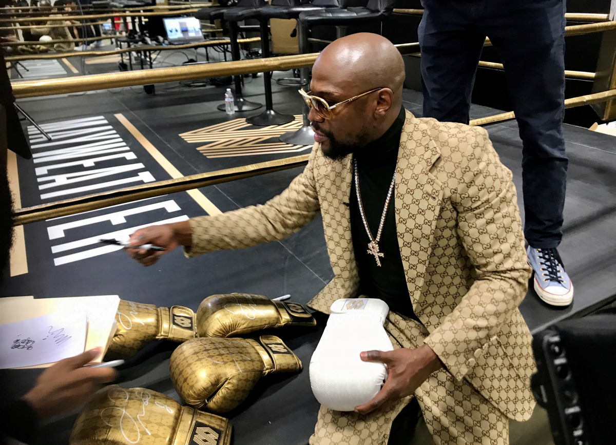 FILE PHOTO: Floyd Mayweather signs gloves at the opening of the Mayweather Boxing + Fitness gym in Torrance, California, U.S., November 16, 2019. REUTERS/Rory Carroll/File Photo
