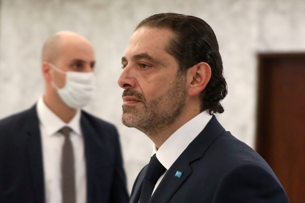 FILE PHOTO: Prime Minister-designate Saad al-Hariri walks by after meeting with Lebanon's President Michel Aoun at the presidential palace in Baabda, Lebanon March 22, 2021. REUTERS/Mohamed Azakir/File Photo