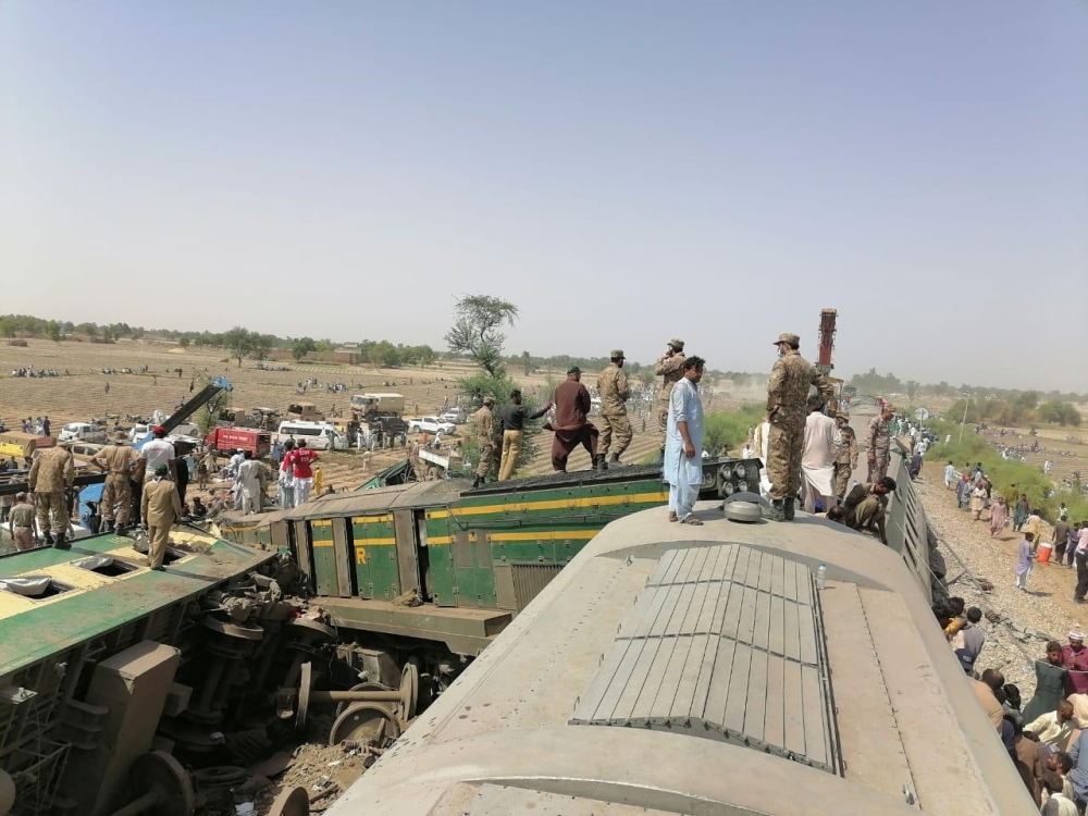 Paramilitary soldiers and rescue workers gather at the site following a collision between two trains in Ghotki, Pakistan June 7, 2021. Inter-Services Public Relations (ISPR)/ Handout via REUTERS