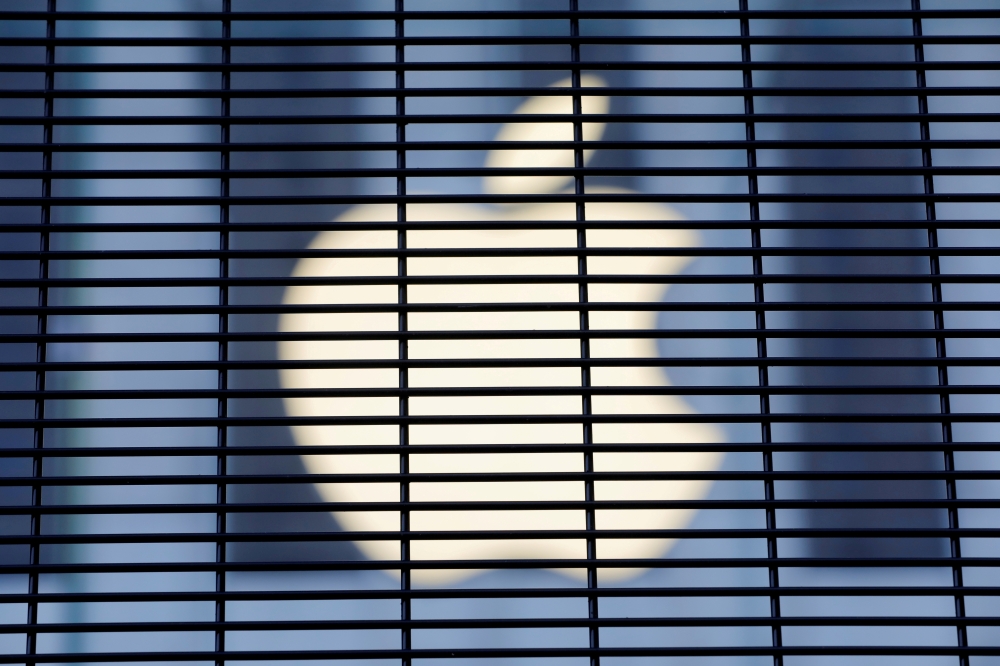 The Apple logo is seen through a security fence erected around the Apple Fifth Avenue store. Reuters/Andrew Kelly/File Photo