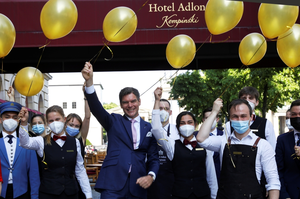 Hotel Director Michael Sorgenfrey poses with employees as they prepare to receive guests at the Hotel Adlon Kempinski after lockdown due to the coronavirus disease (COVID-19) pandemic in Berlin, Germany, June 11, 2021. REUTERS/Michele Tantussi