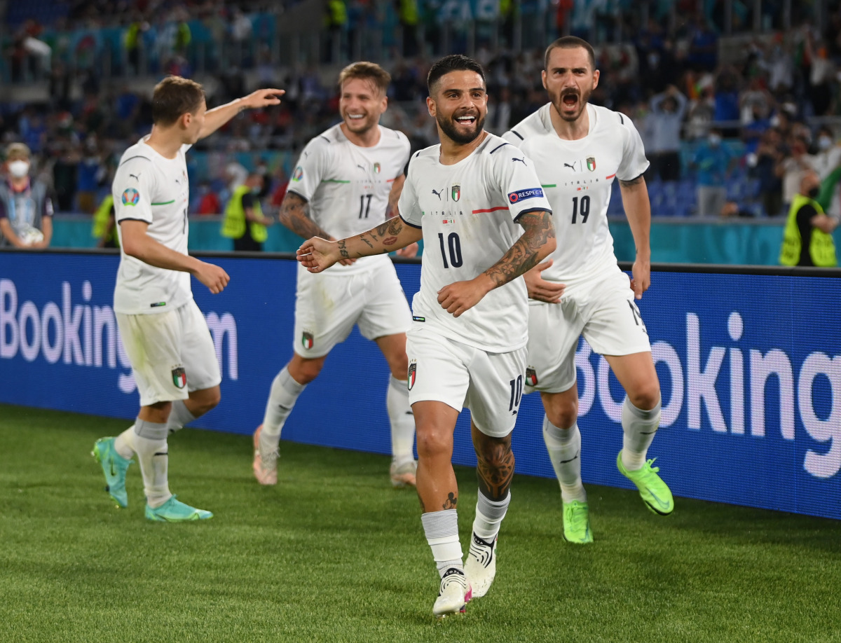 Italy’s Lorenzo Insigne celebrates scoring their third goal with team-mates.
