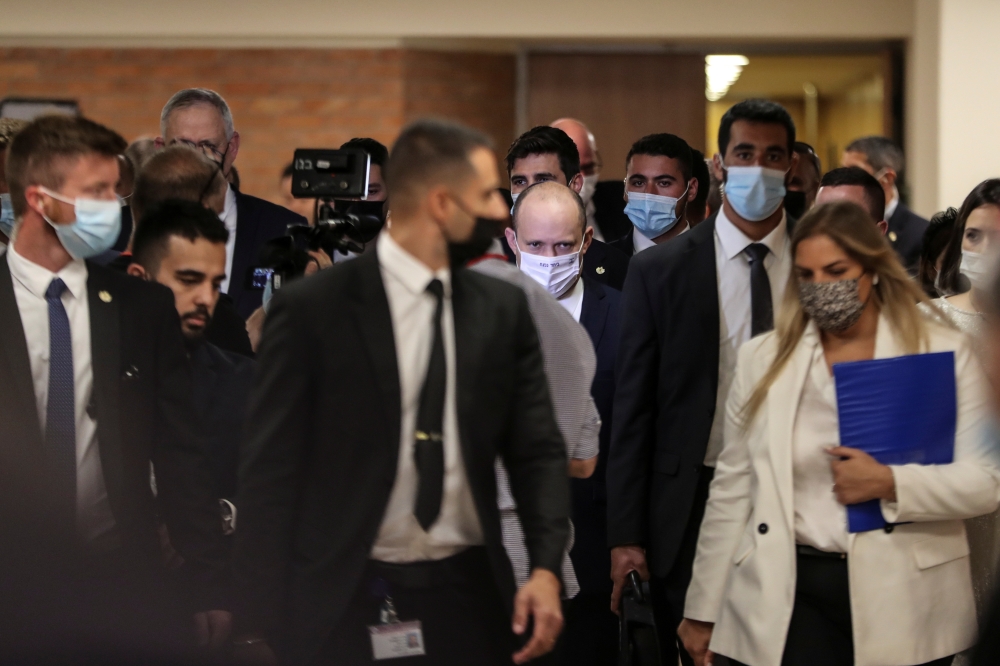 Naftali Bennett, Prime Minister-designate, looks on as he walks at the Knesset, Israel's parliament, before the start of a special session whereby a confidence vote will be held to approve a new coalition government, in Jerusalem June 13, 2021. REUTERS/Ro