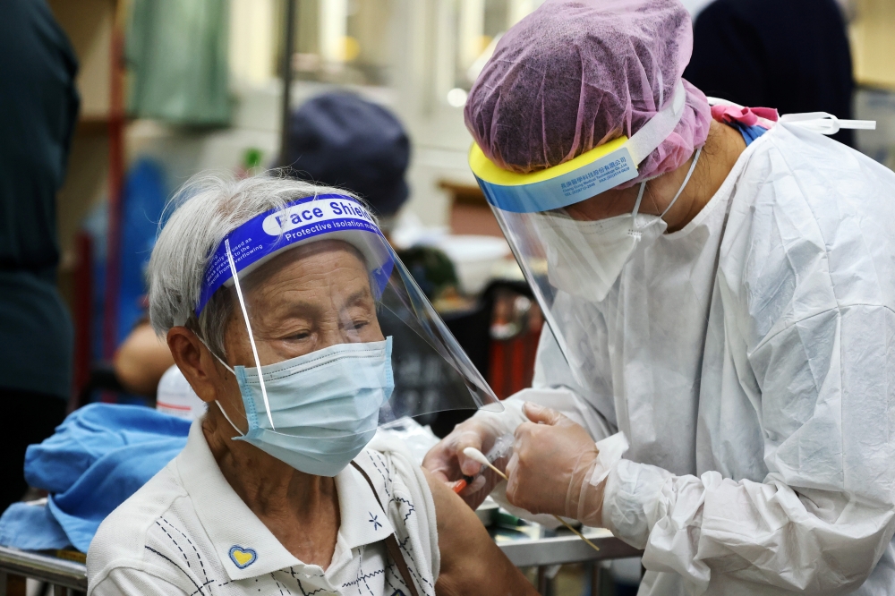 A medical worker administers a dose of the vaccine against the coronavirus disease (COVID-19) for a man during a vaccination session for elderly people over 85 years old, at a school in Taipei, Taiwan June 15, 2021. Reuters/Ann Wang