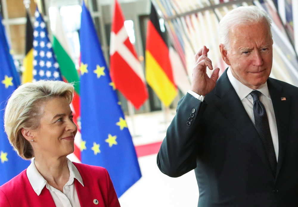 US President Joe Biden crosses his fingers next to European Commission President Ursula von der Leyen as they attend the EU-US summit, in Brussels, Belgium June 15, 2021. Reuters/Yves Herman