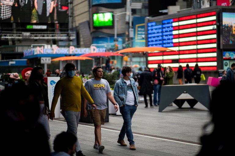FILE PHOTO:People make their way through Times Square, amid the coronavirus disease (COVID-19) pandemic, in Manhattan, New York City, U.S., May 07, 2021. REUTERS/Eduardo Munoz/File Photo
