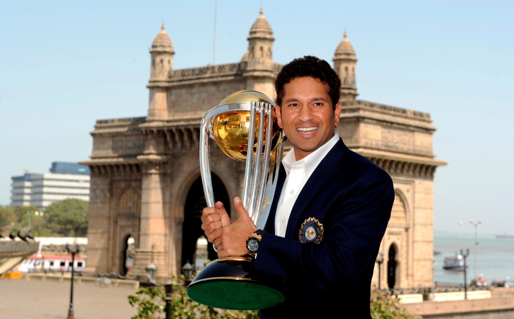 FILE PHOTO: India's Sachin Tendulkar holds the World Cup trophy after India defeated Sri Lanka in the 2011 Cricket World Cup final, in Mumbai April 3, 2011. REUTERS/Philip Brown/File Photo
