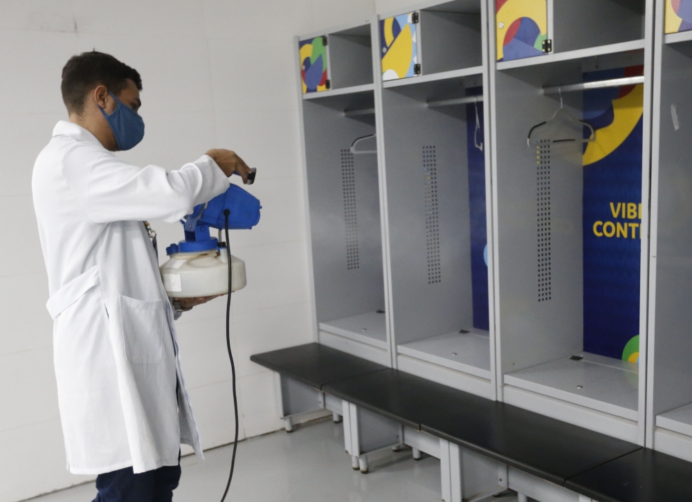 A staff member disinfects the dressing rooms at the Arena. (REUTERS/Mariana Greif)